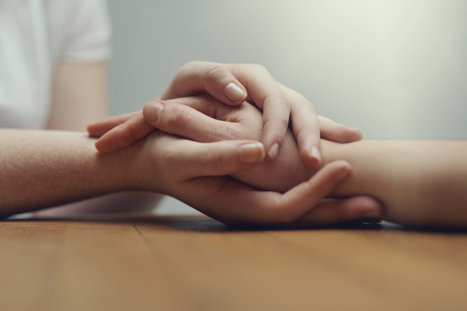 Supporting a dear friend. two people holding hands in comfort