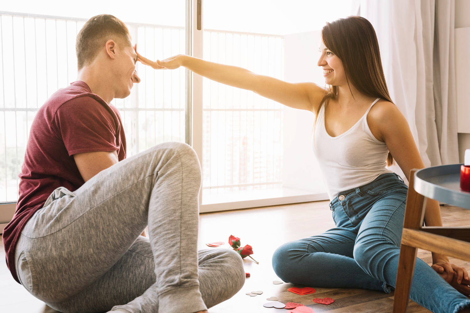 Woman touching head of man with hand