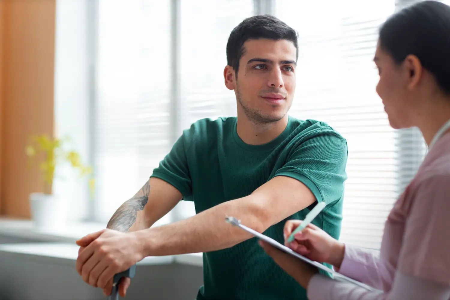 Doctor helping patient during rehabilitation